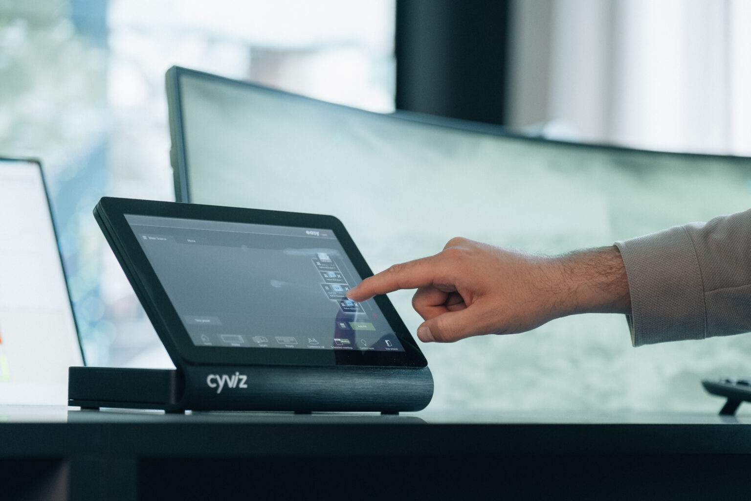 Several screens. A finger is about to tap one of them.